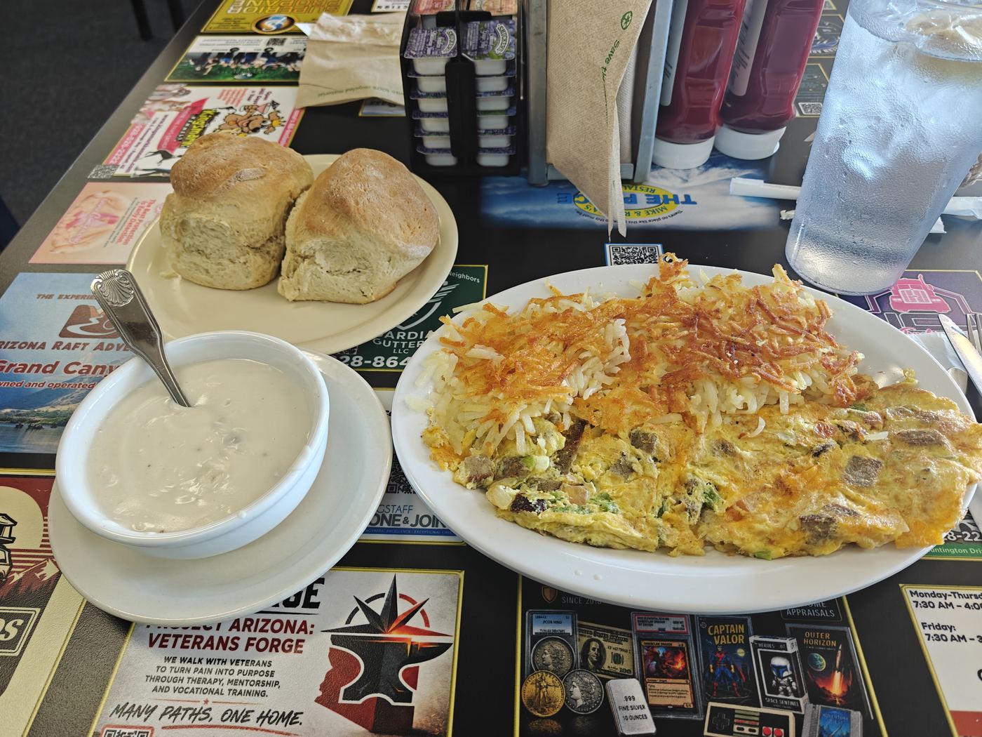 Breakfast plate with omelette, hash browns, biscuits and gravy